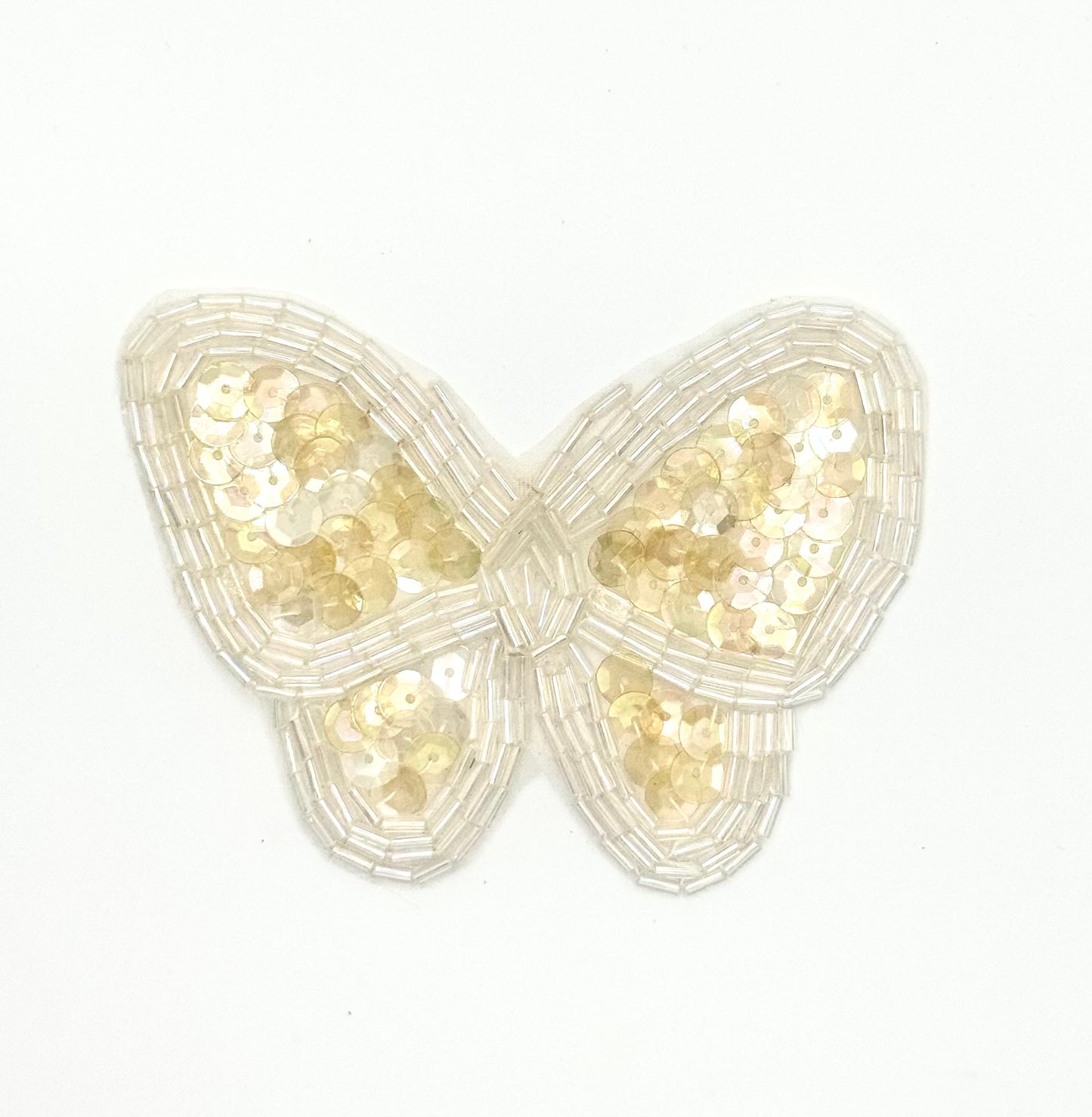 Butterfly-shaped decorative item with iridescent sequins on a white background