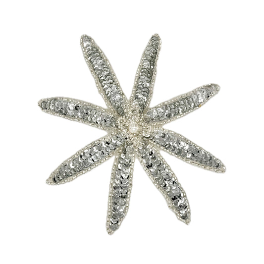 Silver sequin and bead flower on a white background