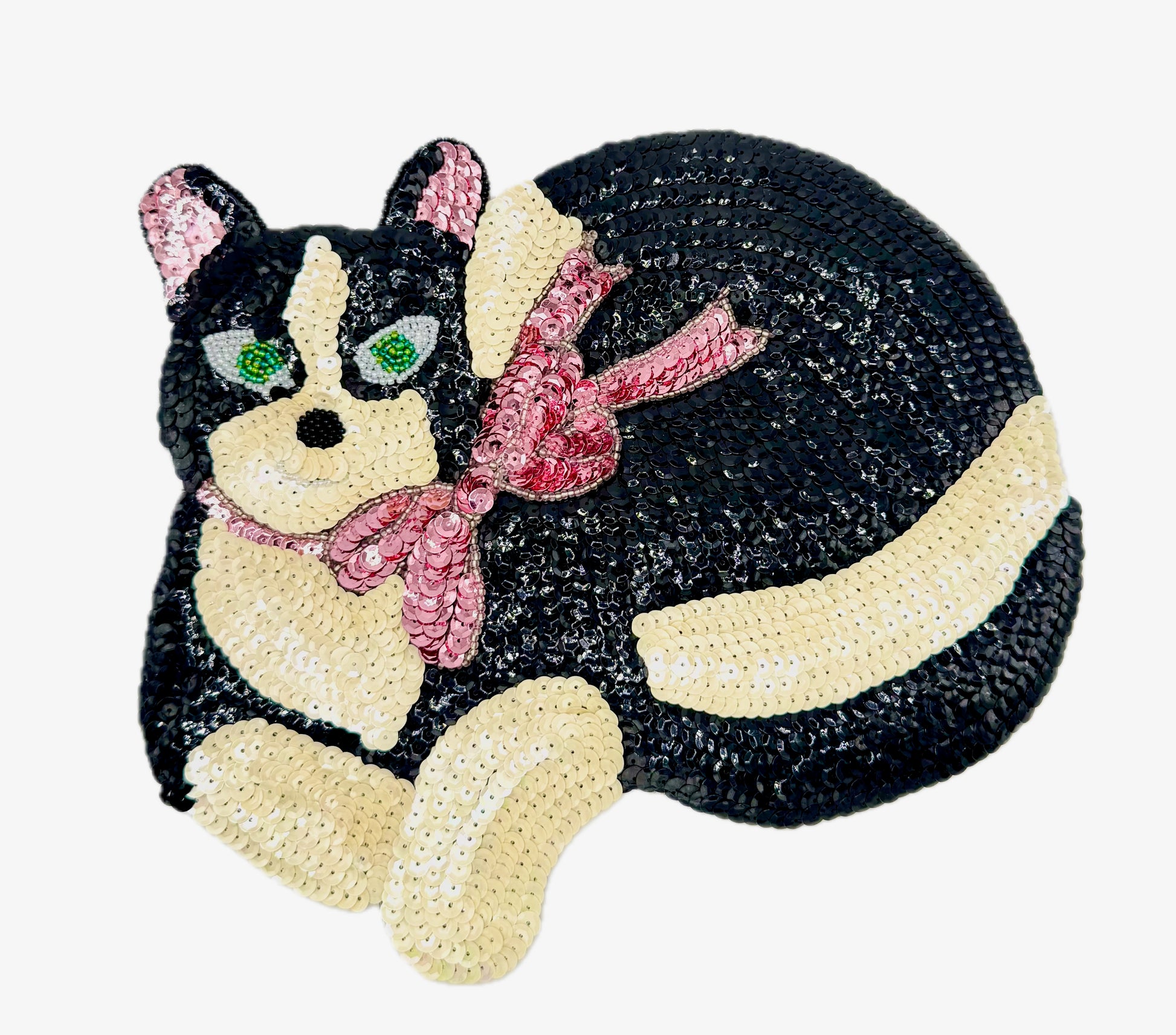 Sequined cat patch with a pink bow on a white background
