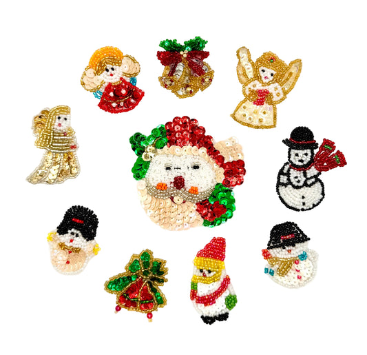 Collection of sequin and bead Christmas-themed decorative patches or pins on a white background