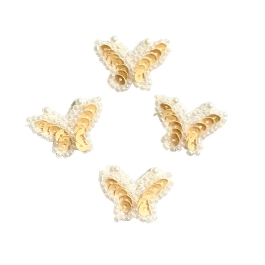 Four beige butterfly-shaped sequin embellishments on a white background