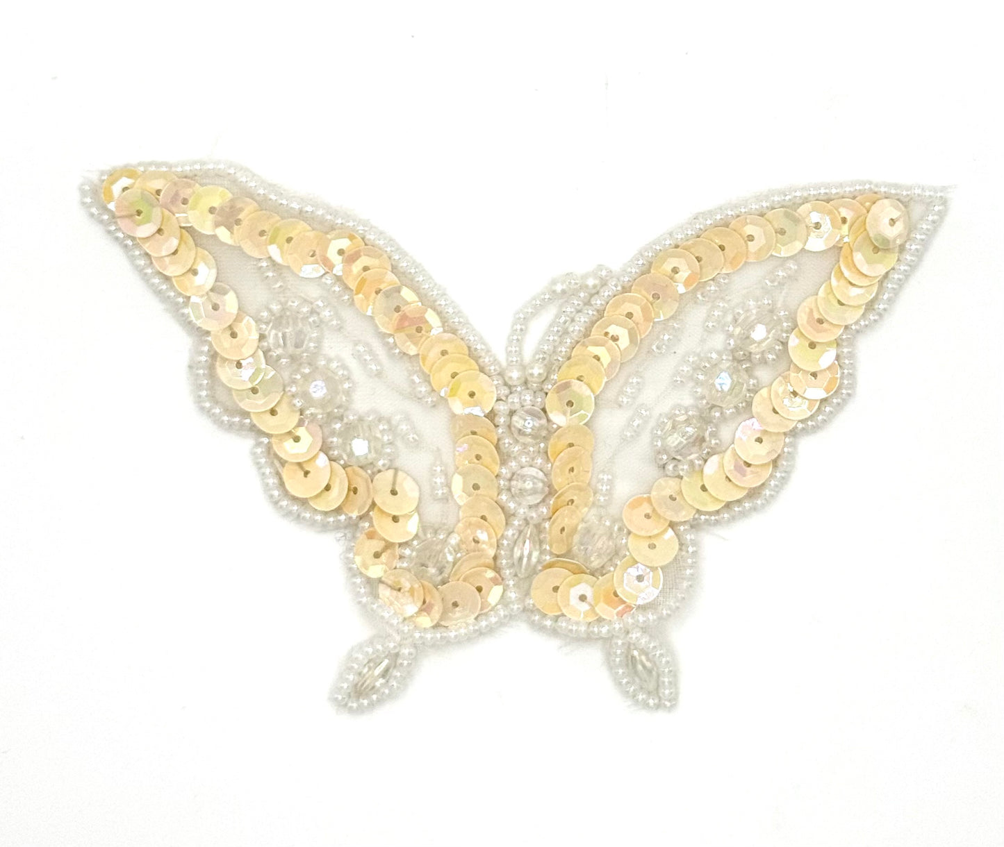 Butterfly-shaped patch with iridescent cream sequins  and  iridescent and white beads on a white background