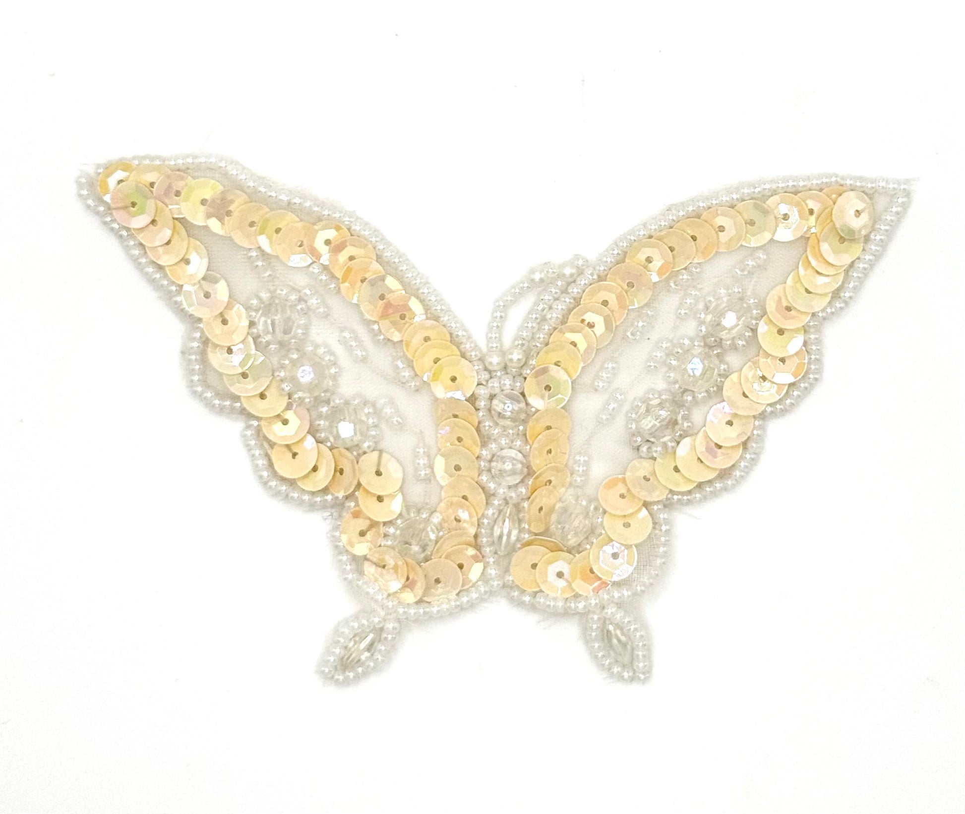 Butterfly-shaped patch with iridescent cream sequins  and  iridescent and white beads on a white background