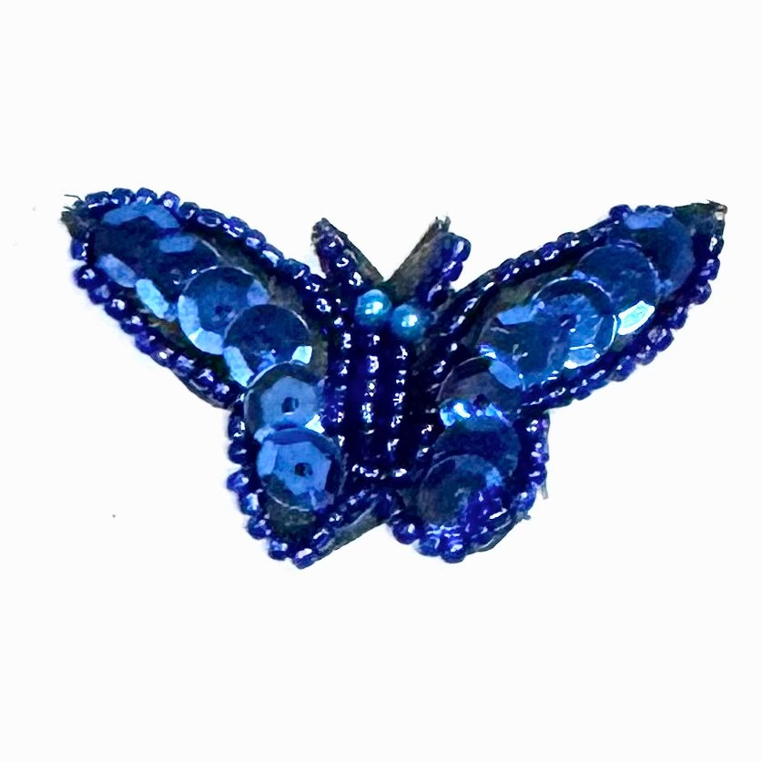 Blue sequin and beaded butterfly on a white background
