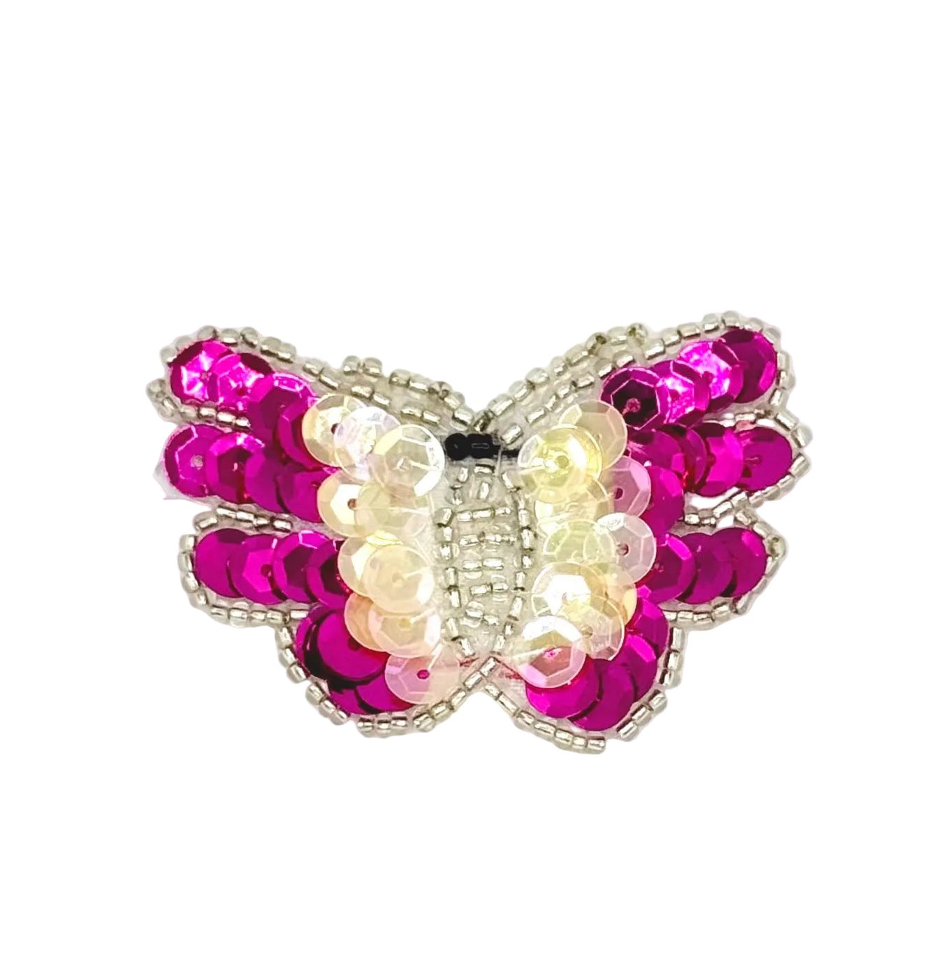 Butterfly-shaped decorative item with fuchsia and iridescent sequins on a white background