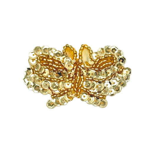 Gold butterfly-shaped patch with beaded details on a white background