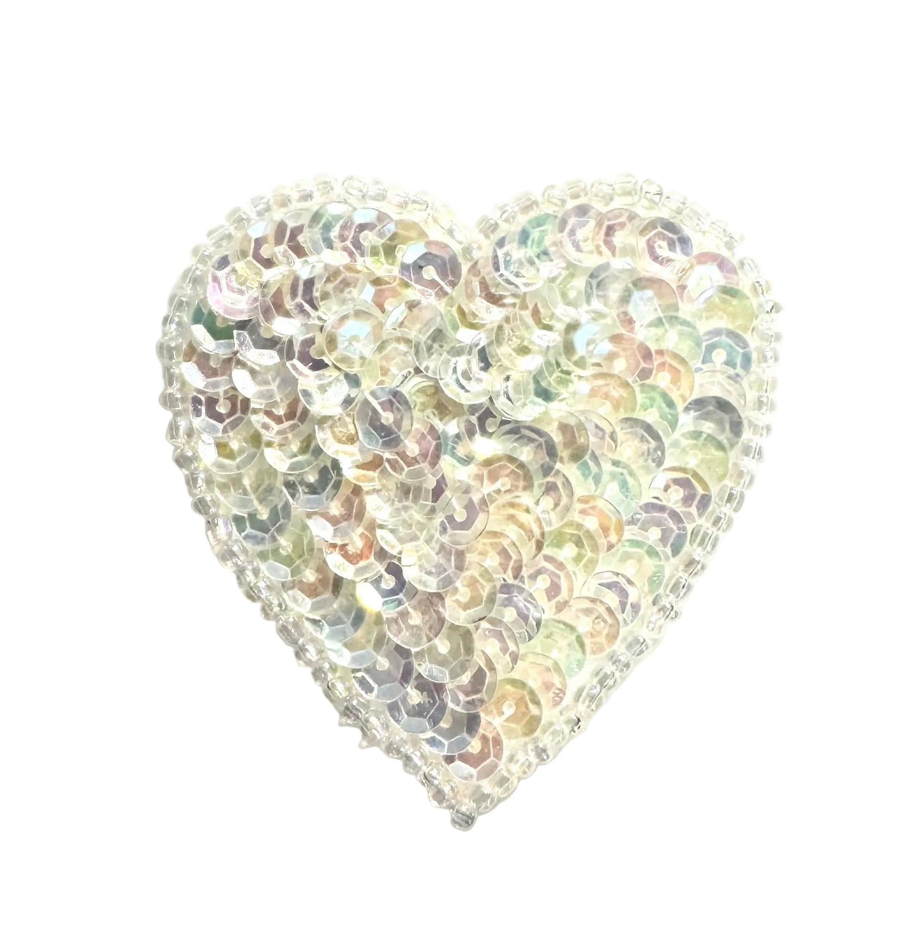 Heart-shaped object with iridescent sequins on a white background