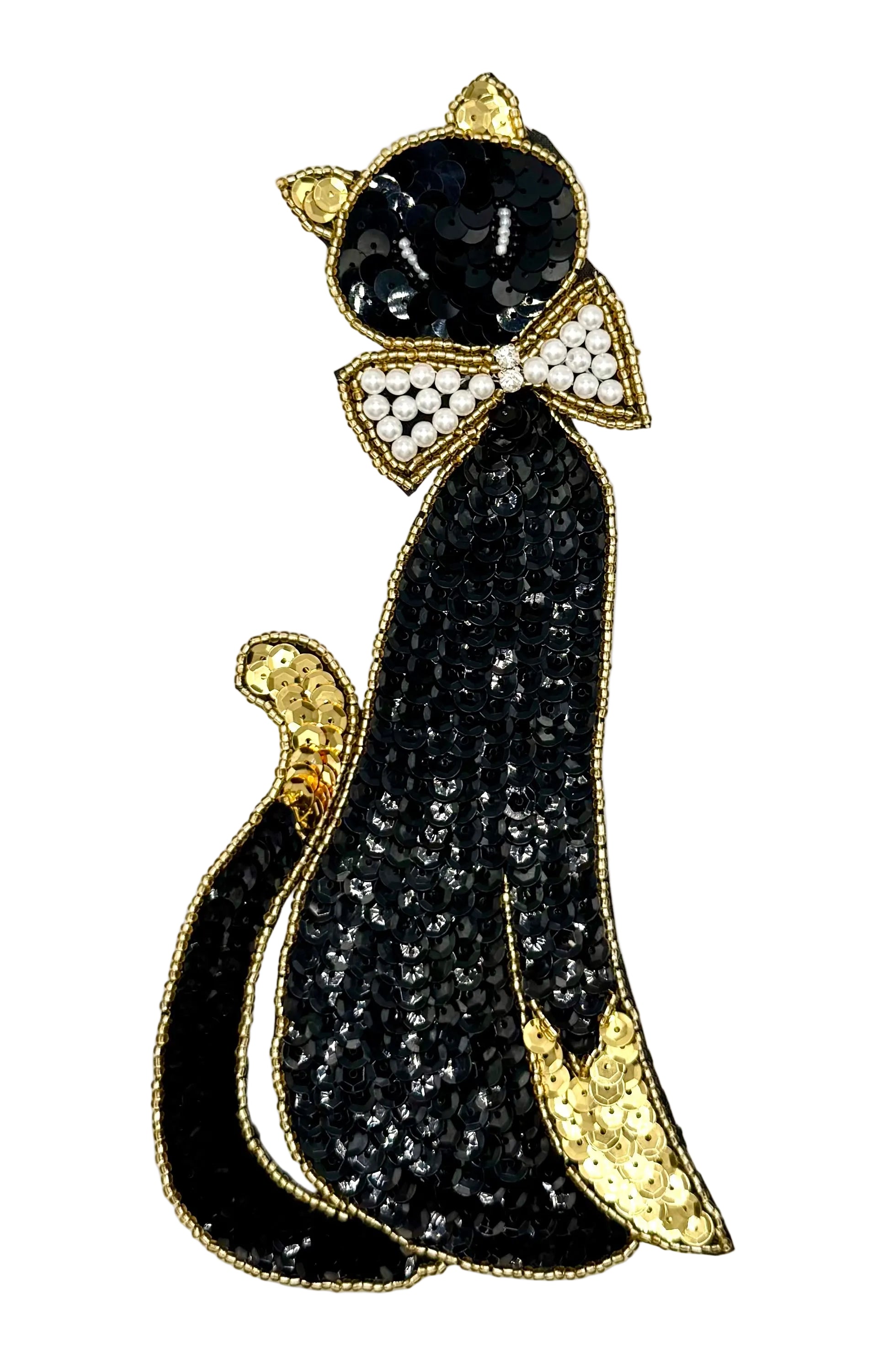 Black sequin and bead cat with a pearl bead and rhinestone bow on a white background 