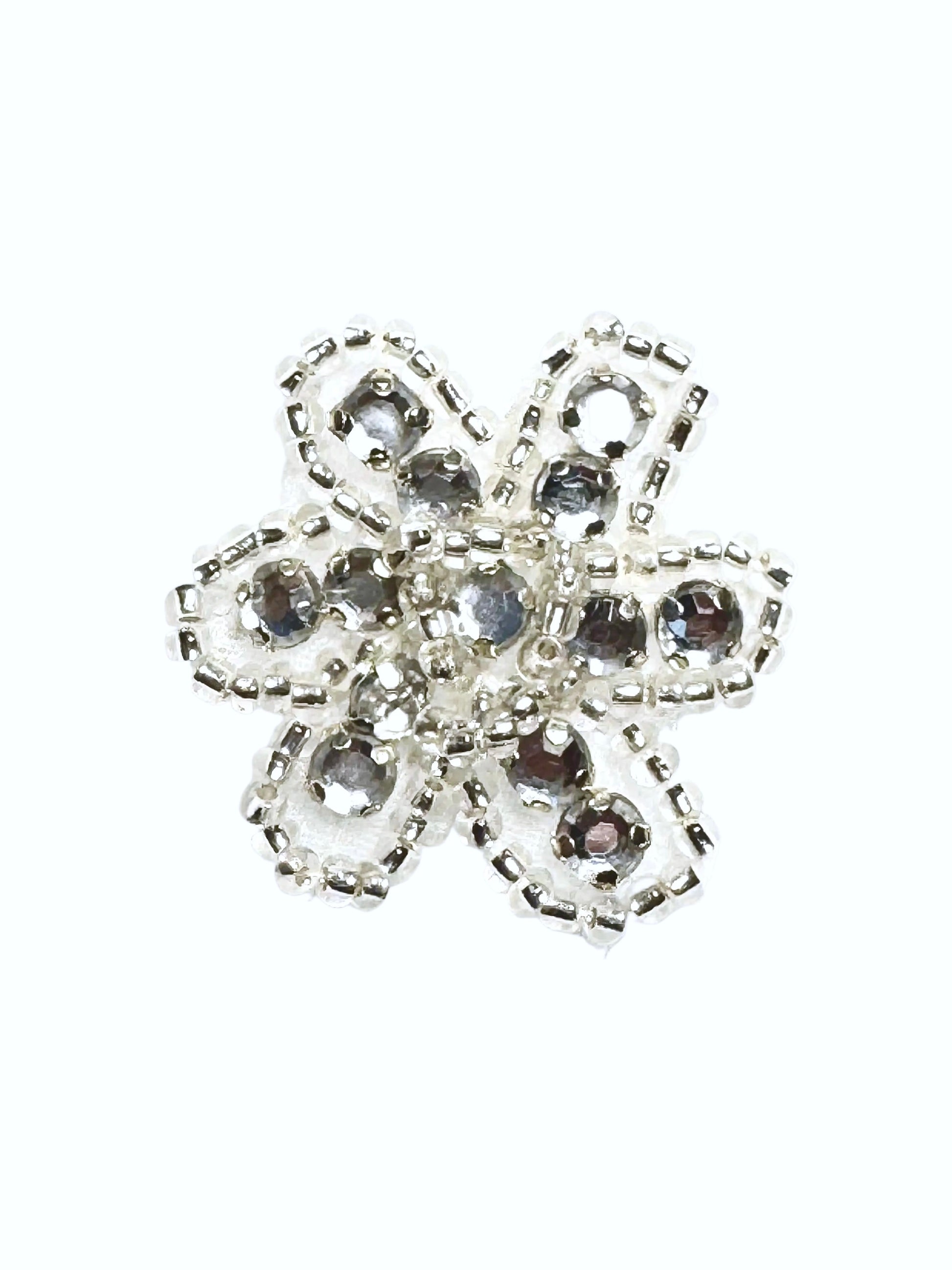 Beaded and rhinestone silver and clear flower on a white background