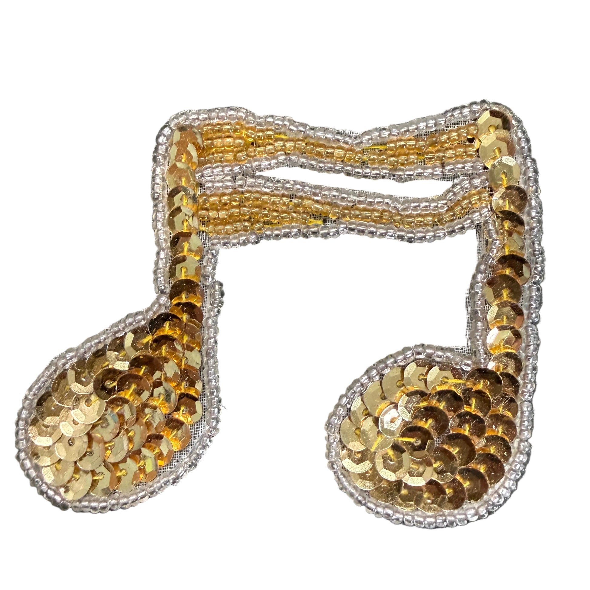 A gold sequined musical note patch with a silver embroidered border, shown on a white background.