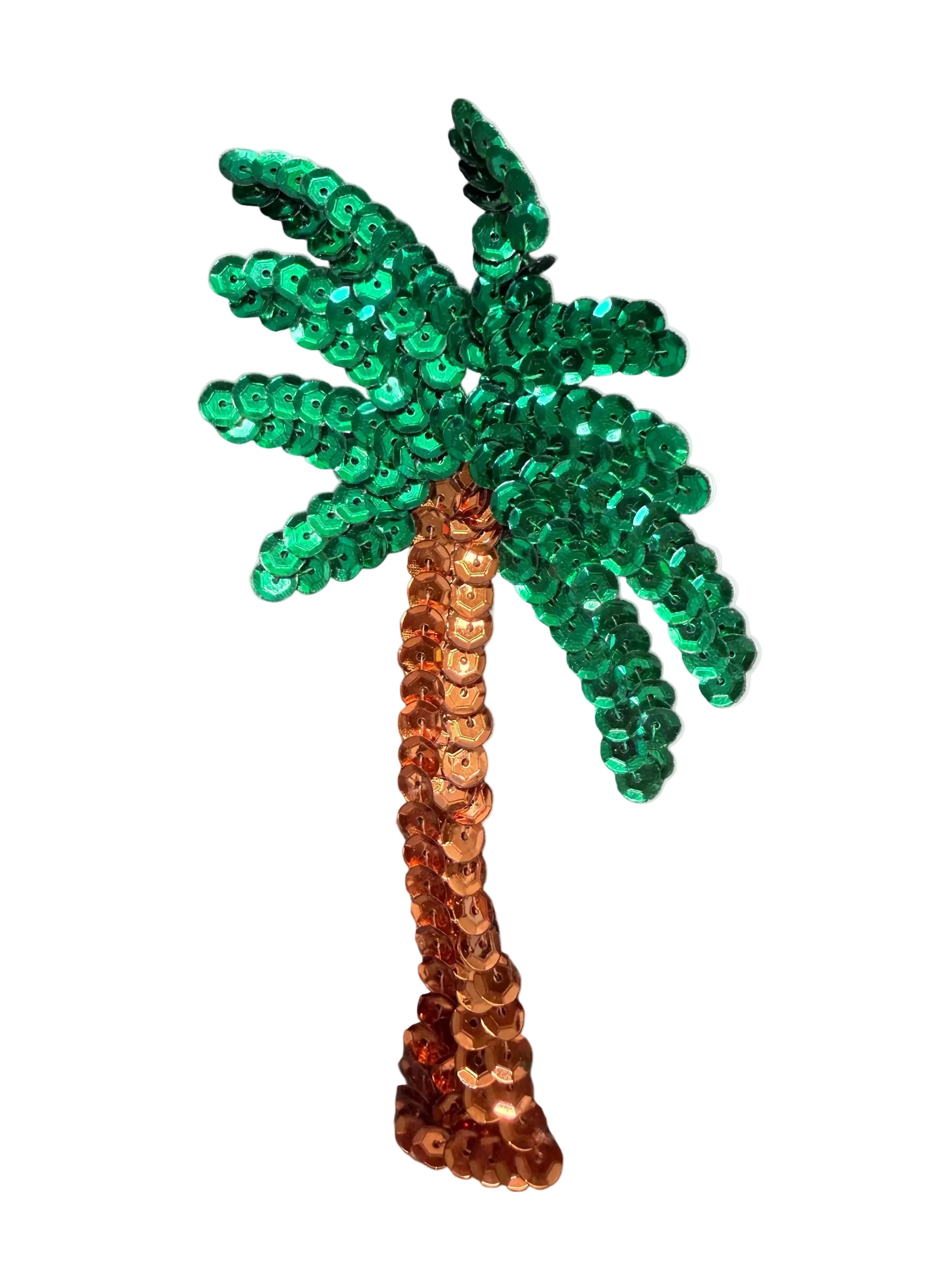 A sequined palm tree appliqué with a green sequin frond and a copper-orange sequin trunk, shown on a textured gray background.