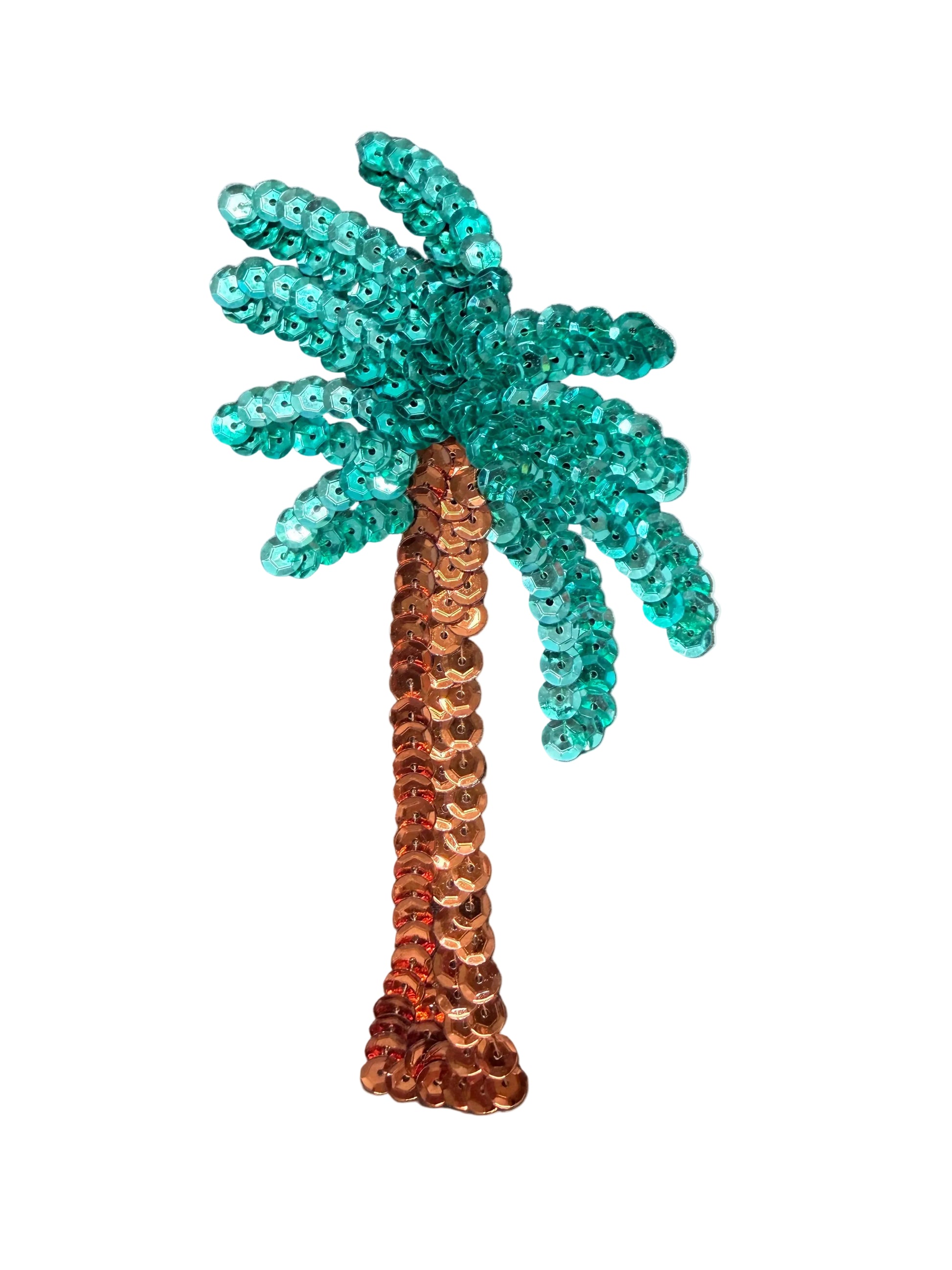 A sequined palm tree decoration or accessory with teal-green leaves and a copper-brown trunk, placed on a white background. 