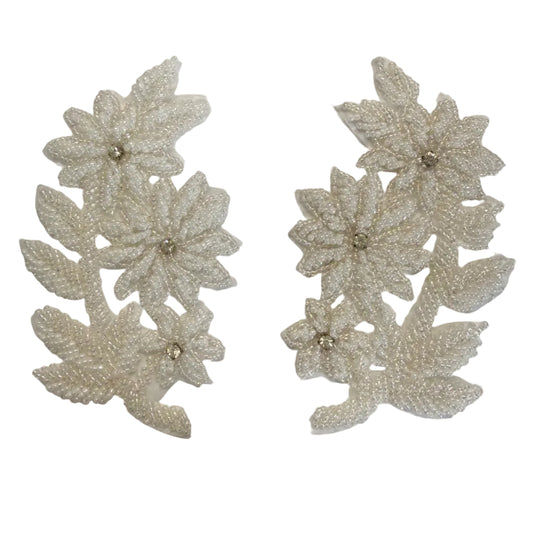 Two white beaded floral appliques with small pearl-like centers, displayed side by side on a white background.