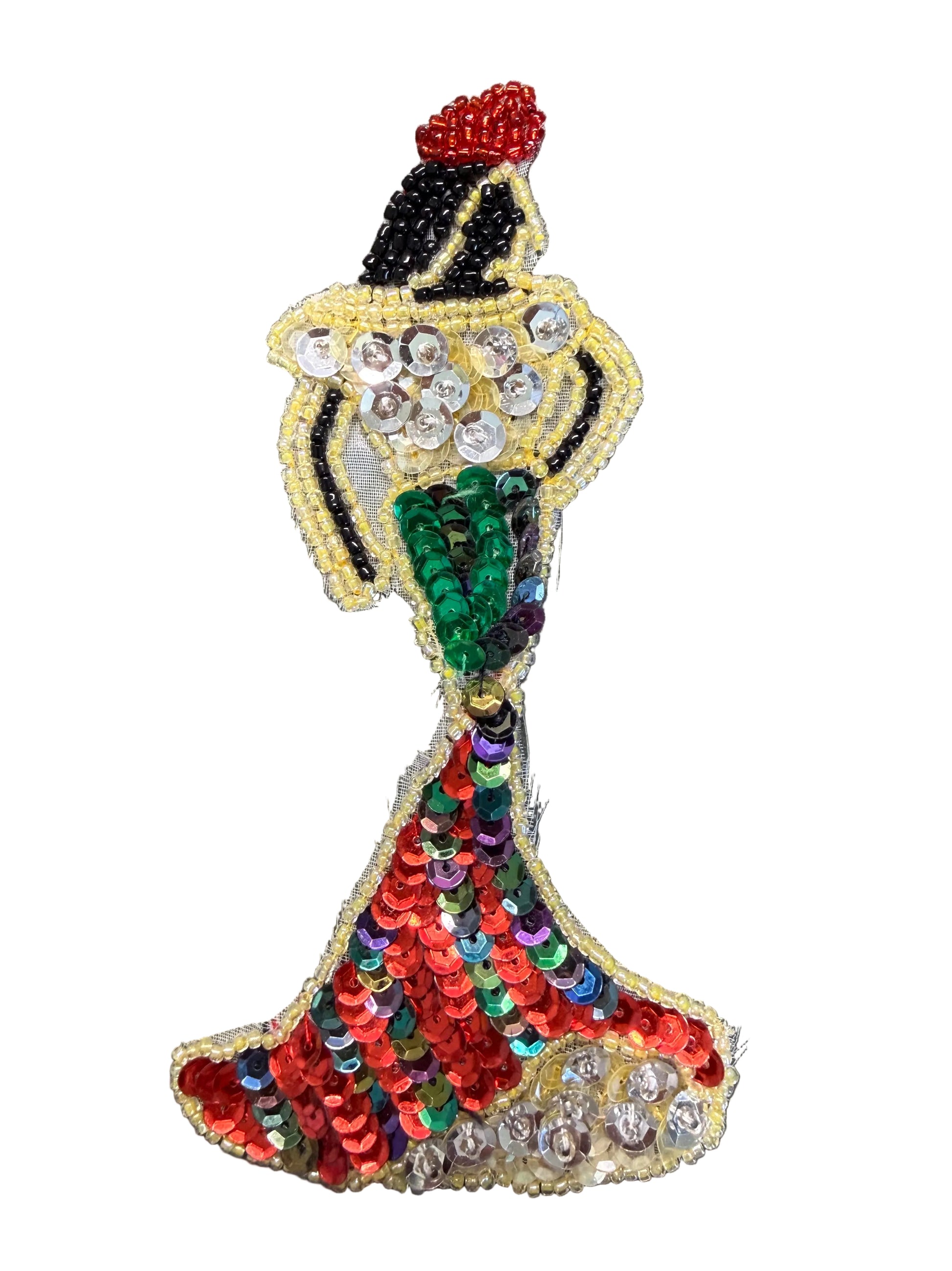 A decorative sequin and bead applique patch shaped like a woman in a flowing dress, featuring red, green, black, yellow, and silver elements, shown against a white background