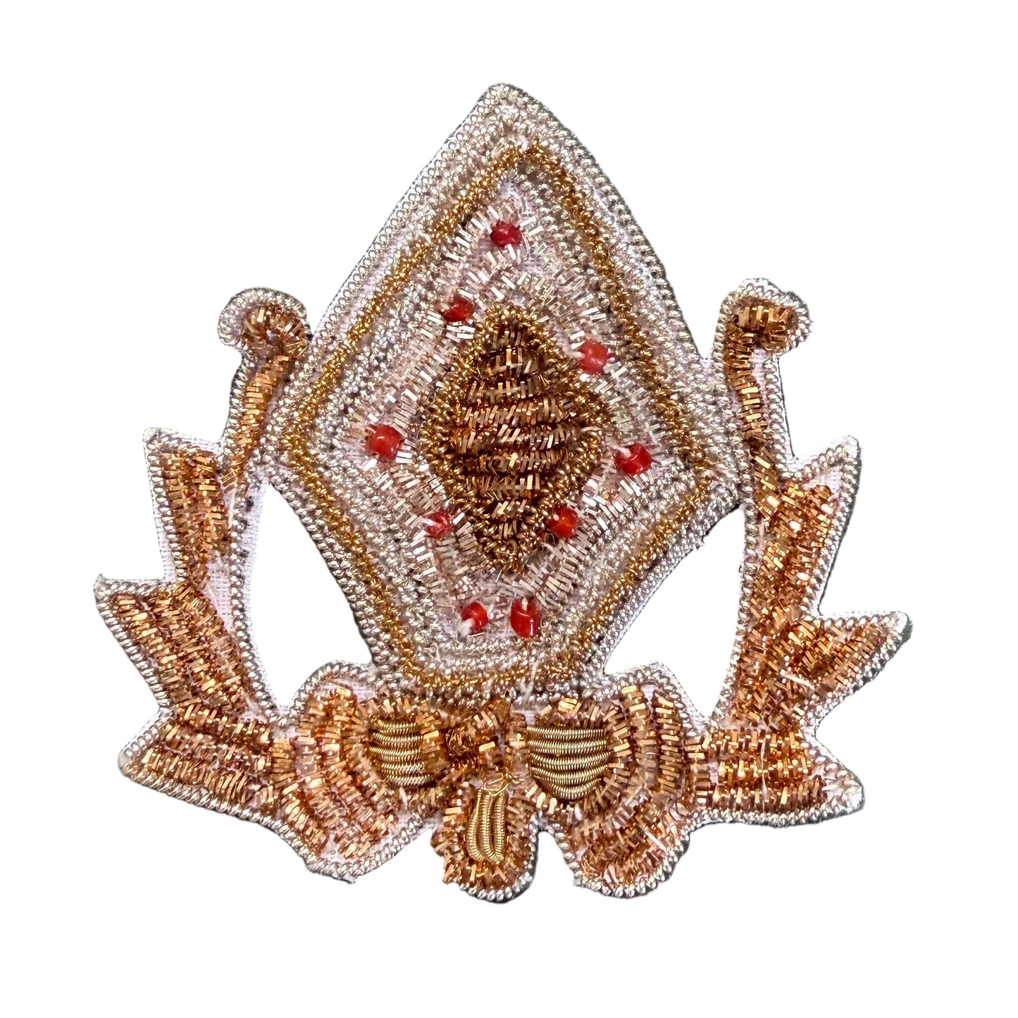A decorative embroidered patch featuring a diamond-shaped design with a central pinecone motif, surrounded by red berry-like accents and a bow at the bottom.