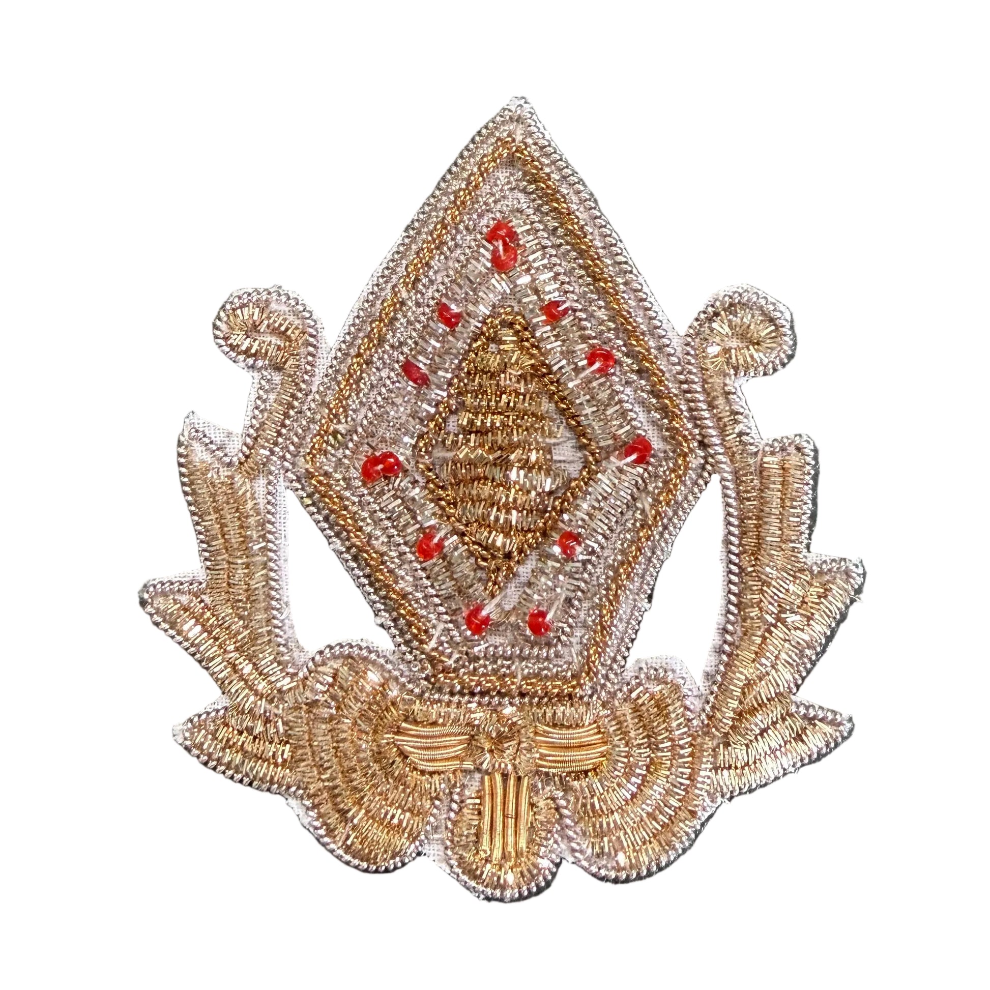 A decorative embroidered patch featuring a diamond-shaped central motif with red bead accents and ornate side scroll details.