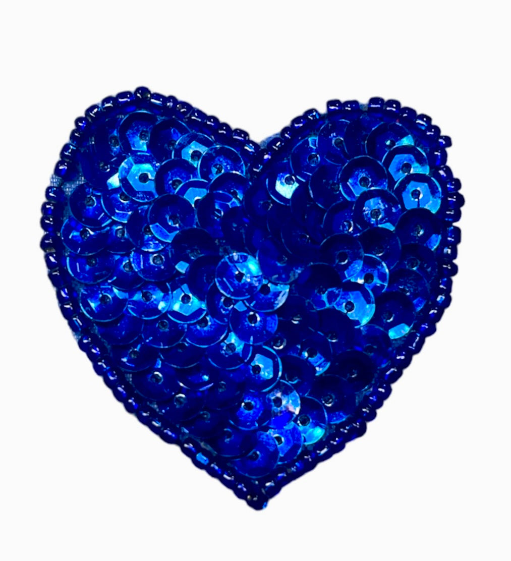 Blue heart-shaped patch with sequins on a white background