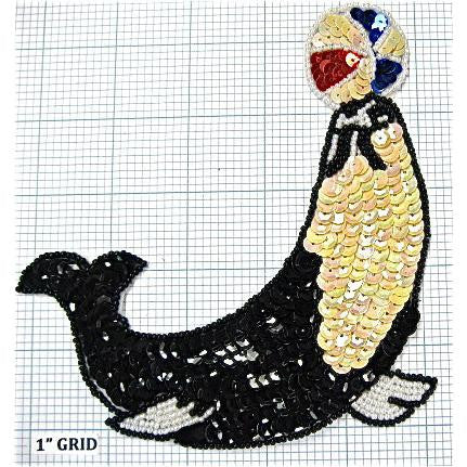 Seal Holding Up a Ball with Black, red, blue and Iridescent White Sequins and Black and White Beads 5.75" X 5.5"